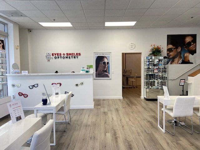 The inside of an optical shop with tables and chairs