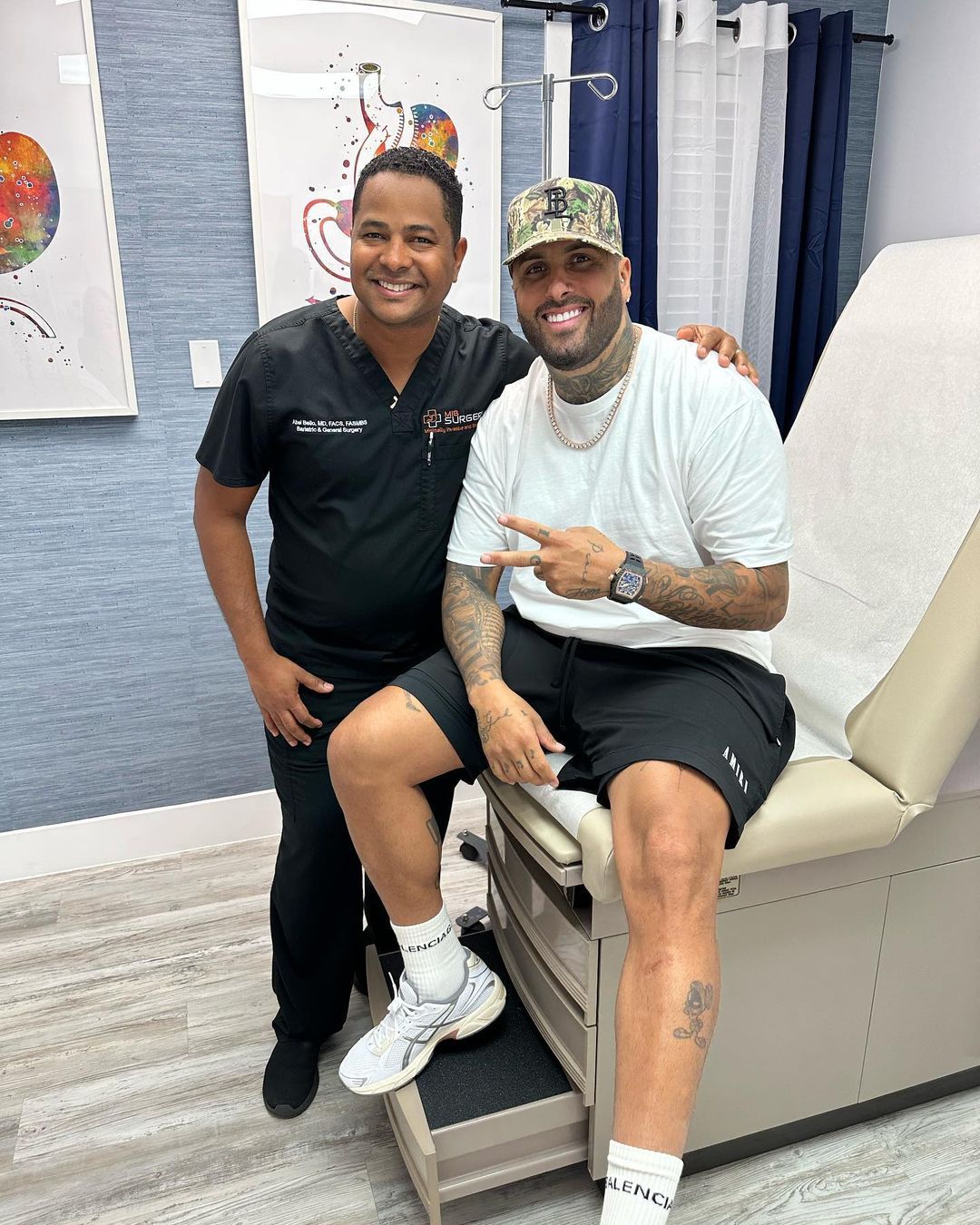 A man is sitting on a medical chair next to a doctor.