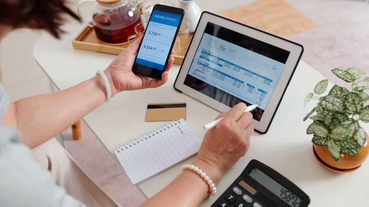 A person entering banking details on a laptop.