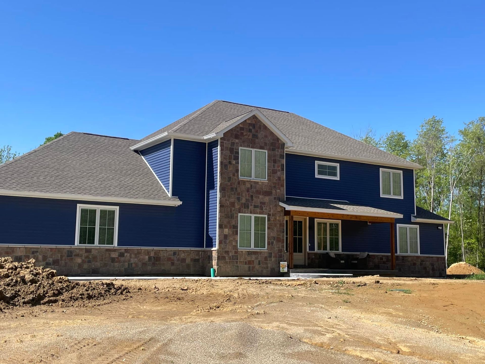 A house with a deck and a pergola in the backyard