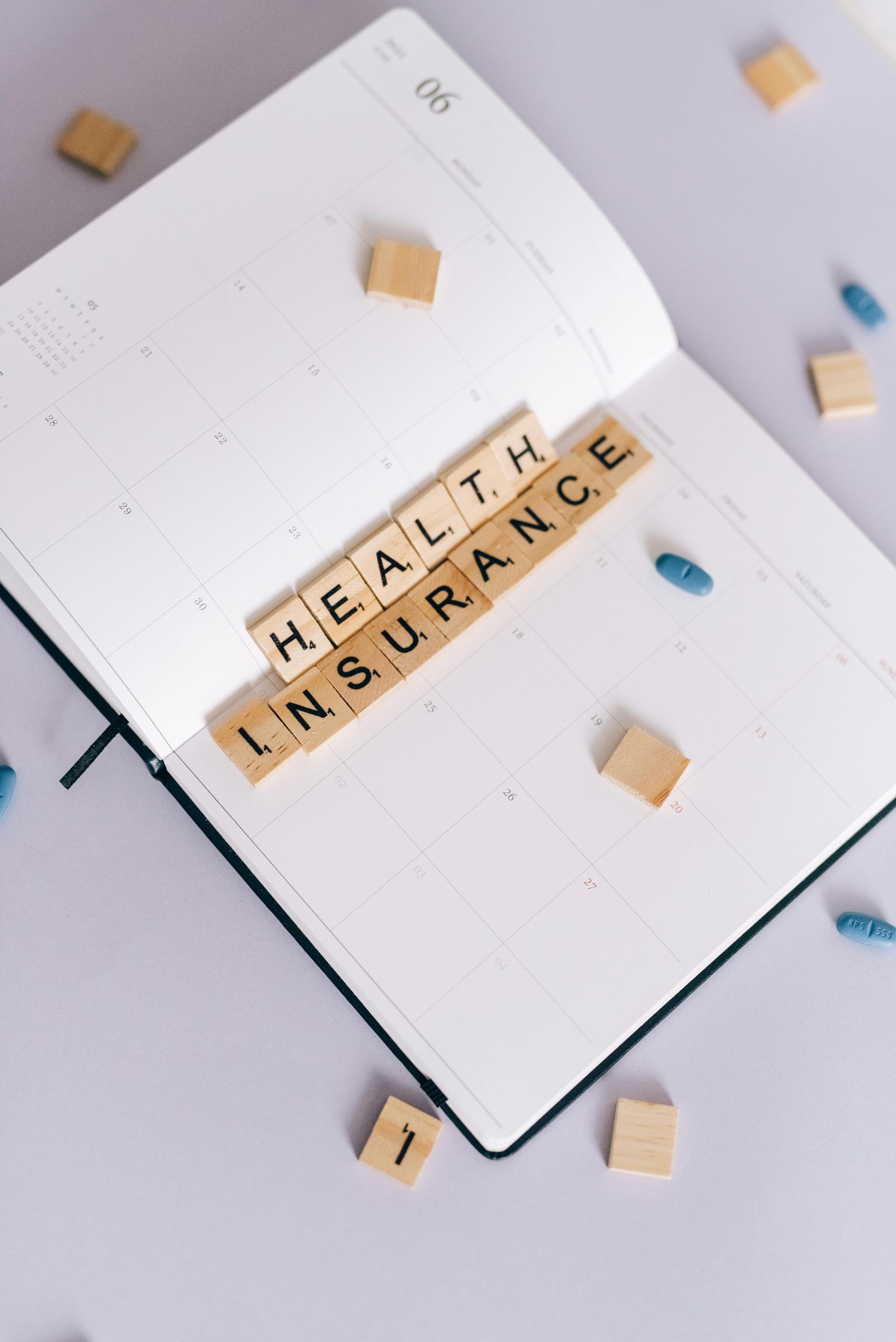 A notebook is open to a page that says health insurance