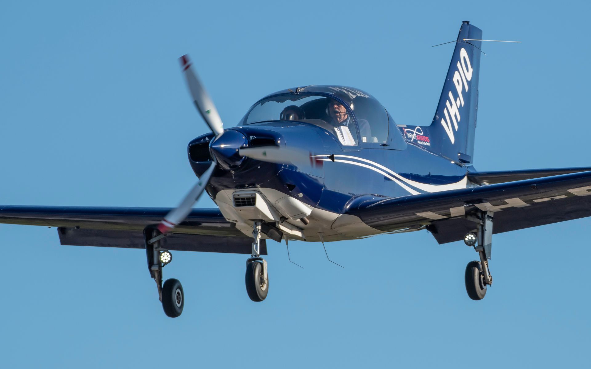 a small propeller plane is flying in the sky .