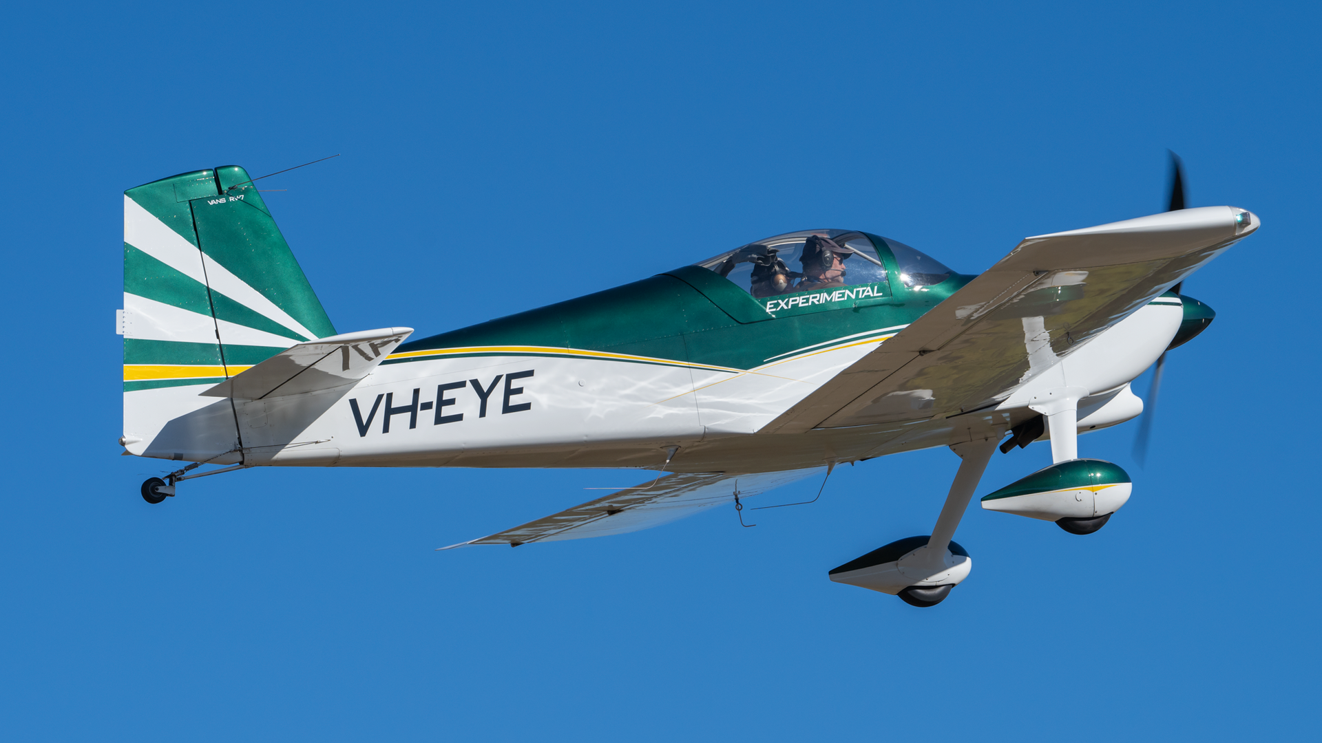 A green and white plane with the letters vheye on the side