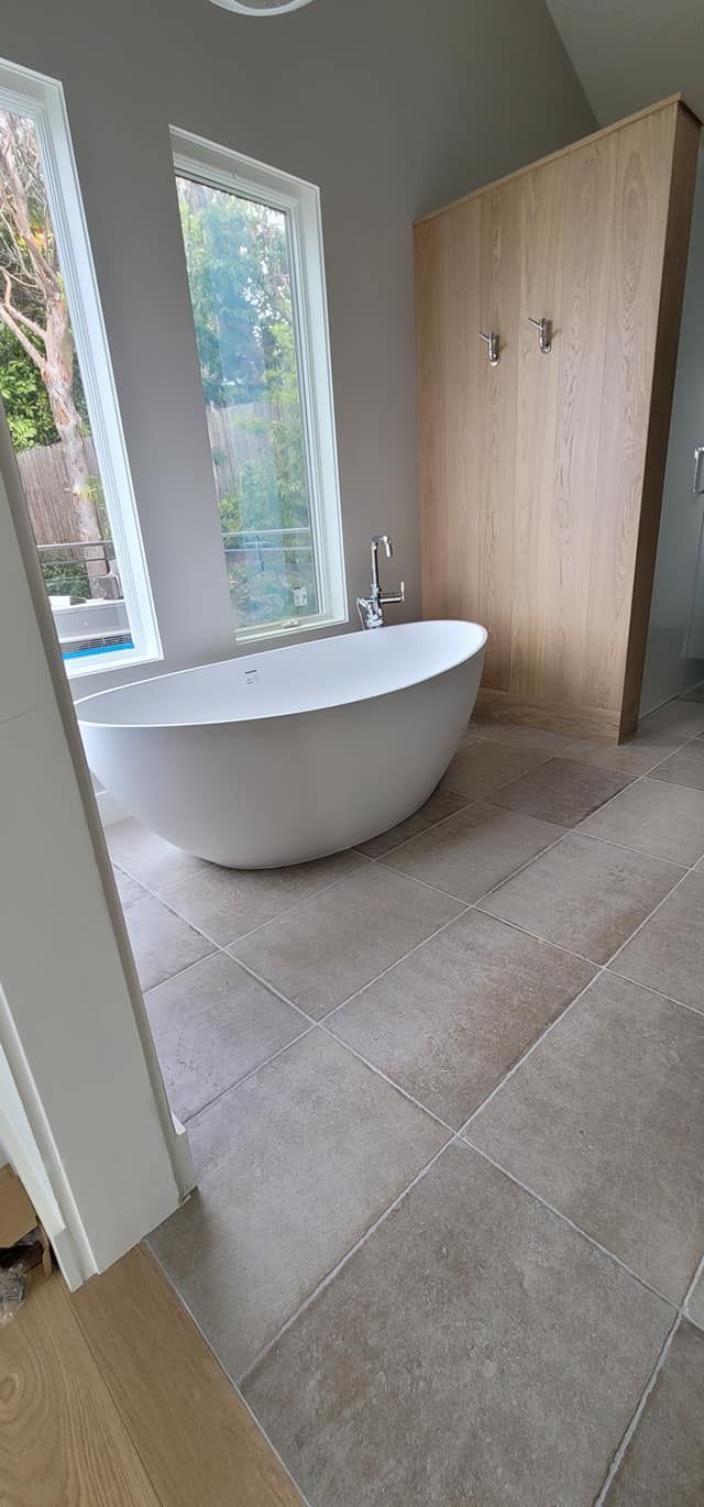 There is a bathtub in the middle of the bathroom.