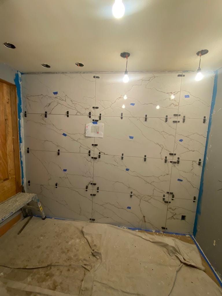 A room that is being remodeled with tiles on the wall.