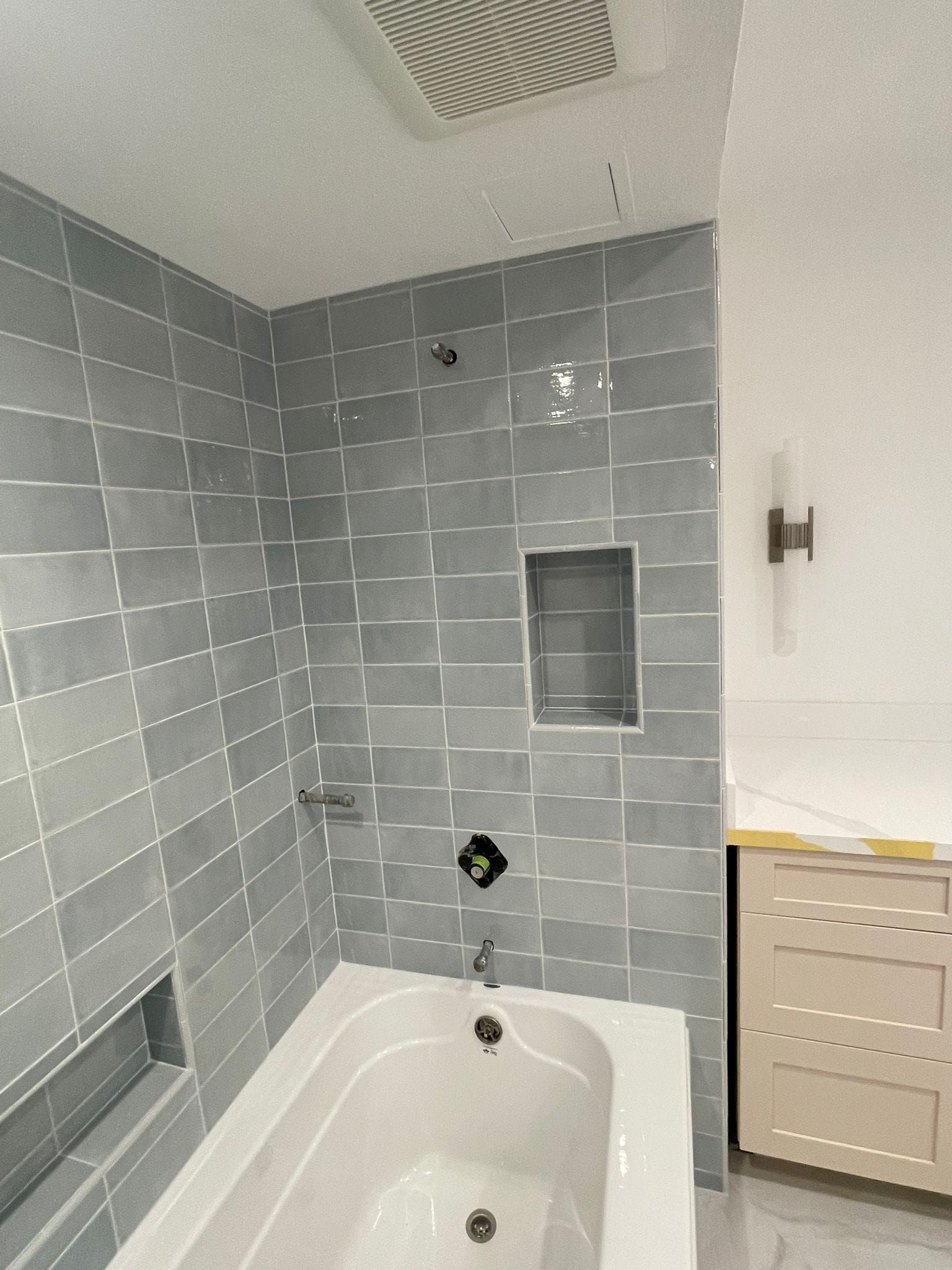 A bathroom with a bathtub and a shower.