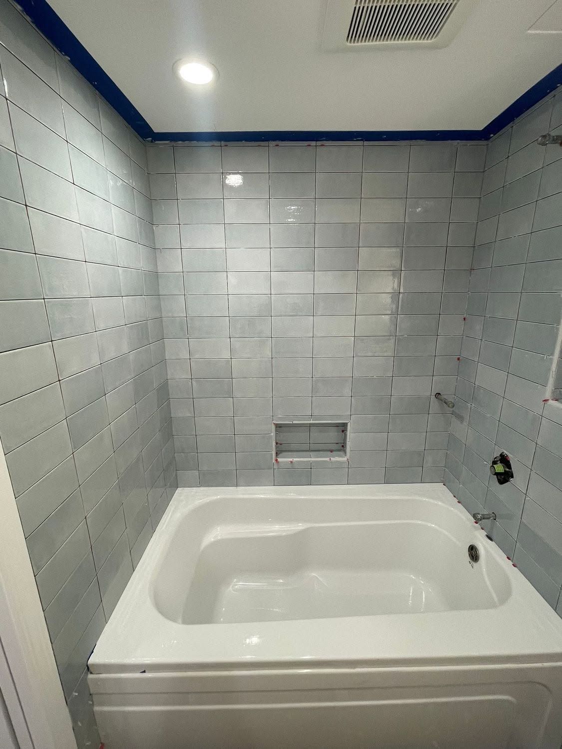 A bathroom with a bathtub and a shower.