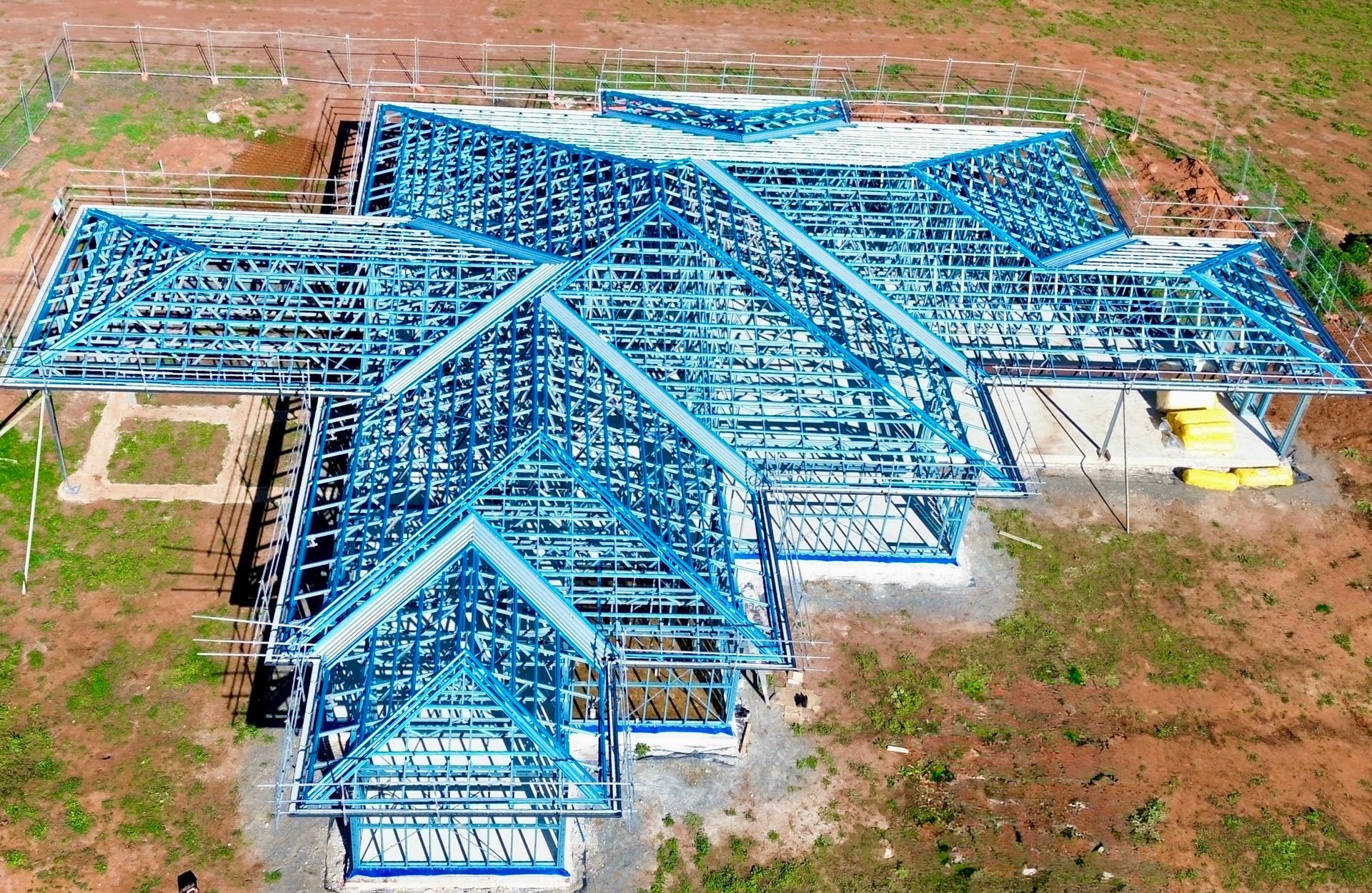 An Aerial View of a House Under Construction in a Field — Essential Roofing and Plumbing in Wagga Wagga, NSW