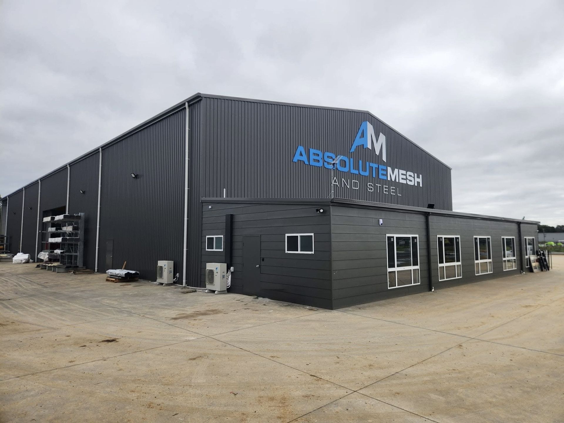 A dark grey metal building — Essential Roofing and Plumbing in Wagga Wagga, NSW