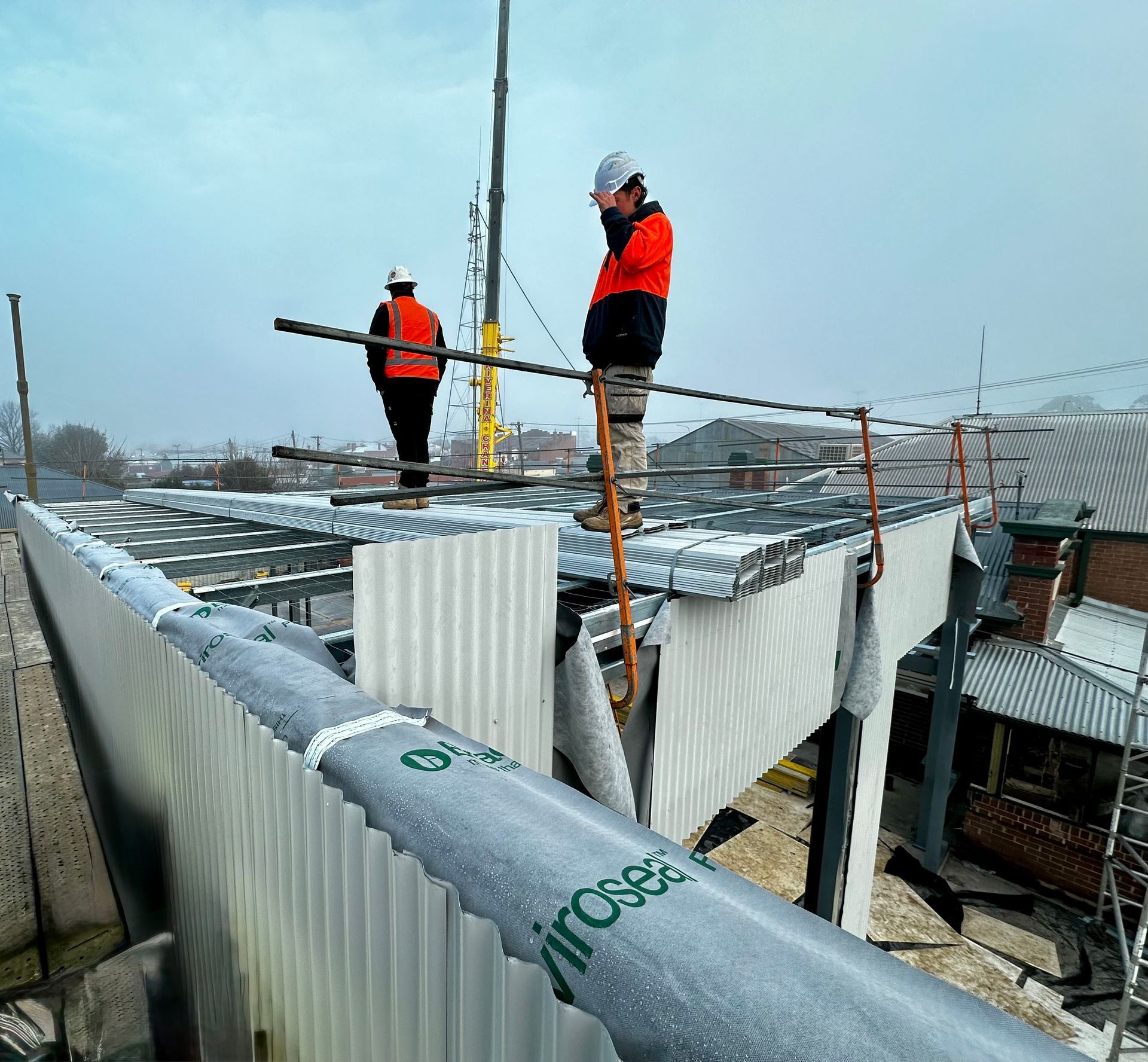 Two Men in high vis working on a roof — Essential Roofing and Plumbing in Wagga Wagga, NSW