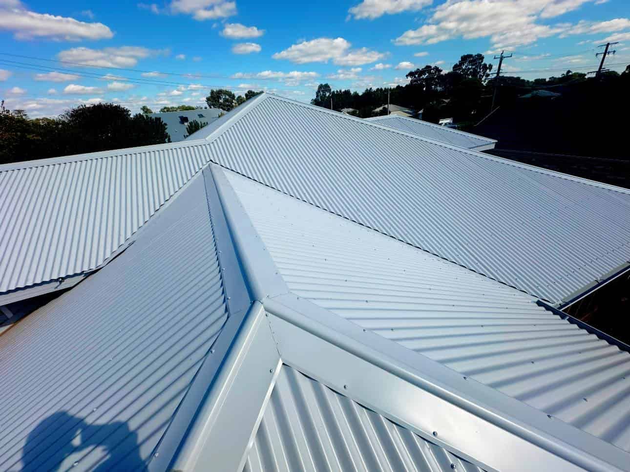 A White Roof With a Blue Sky in the Background — Essential Roofing and Plumbing in Cootamundra, NSW