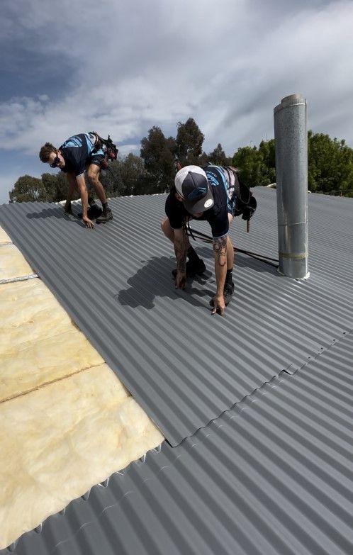 Two Men Working on the Roof of a House — Essential Roofing and Plumbing in Wagga Wagga, NSW
