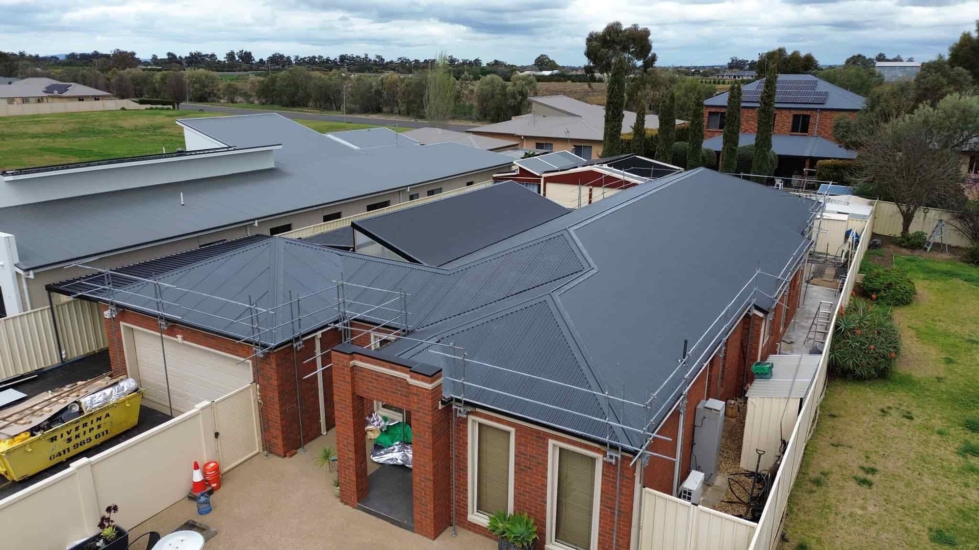 A House with a new roof in a Residential Area on a Sunny Day — Essential Roofing and Plumbing in Narrandera, NSW