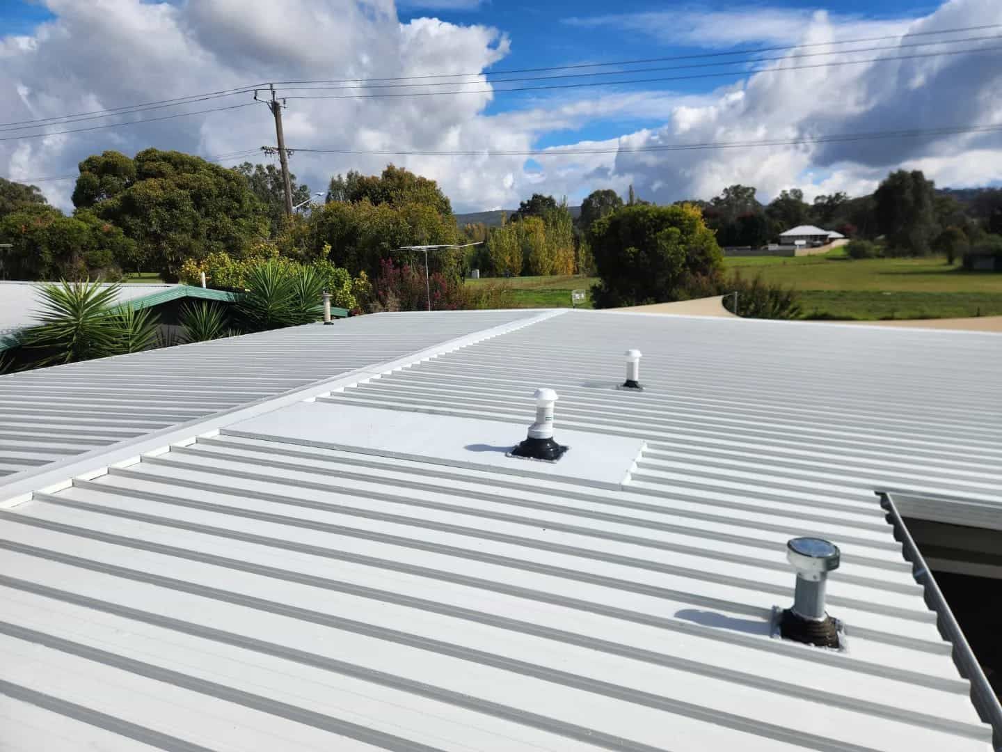 A White Roof With a Blue Sky in the Background — Essential Roofing and Plumbing in Griffith, NSW