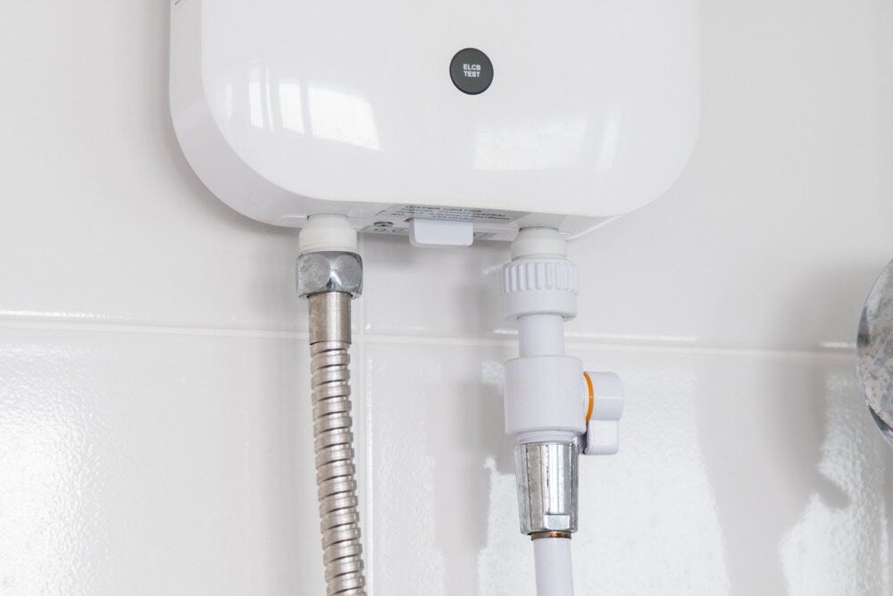 A Close Up of a Shower Head With a Hose Attached to It — Essential Roofing and Plumbing in Griffith, NSW
