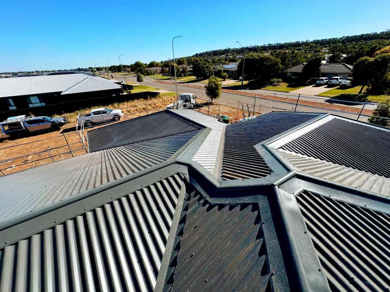An Aerial View of a Roof of a Building in a Residential Area — Essential Roofing and Plumbing in Gundagai, NSW