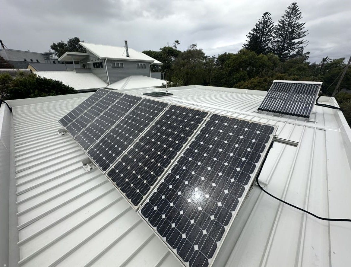 A Row of Solar Panels on a White Roof — Essential Roofing and Plumbing in Temora, NSW