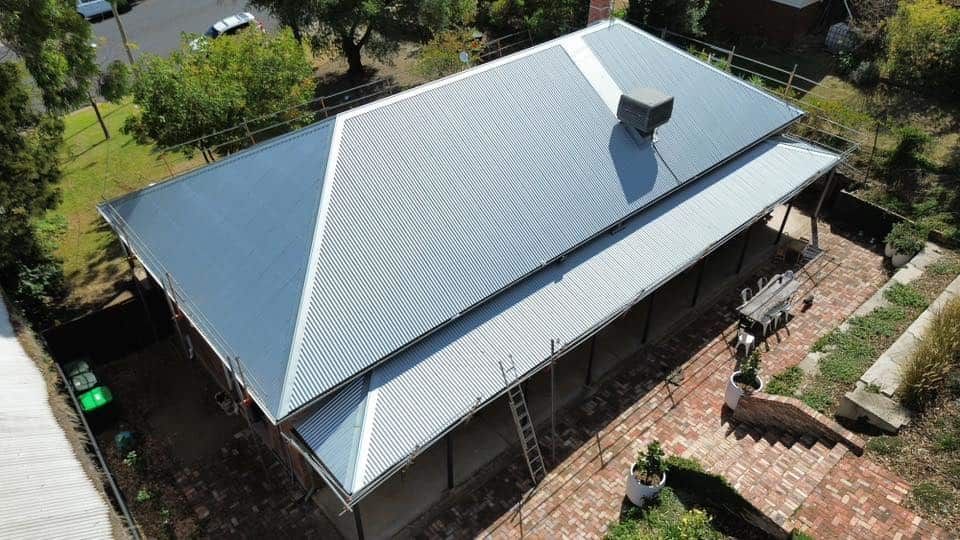 An Aerial View of a House With a Metal Roof — Essential Roofing and Plumbing in Wagga Wagga, NSW