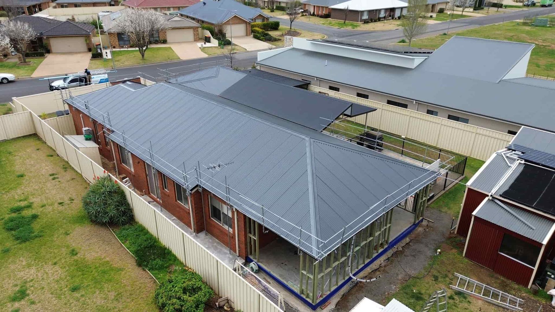 An Aerial View of a House Under Construction in a Residential Area — Essential Roofing and Plumbing in Wagga Wagga, NSW