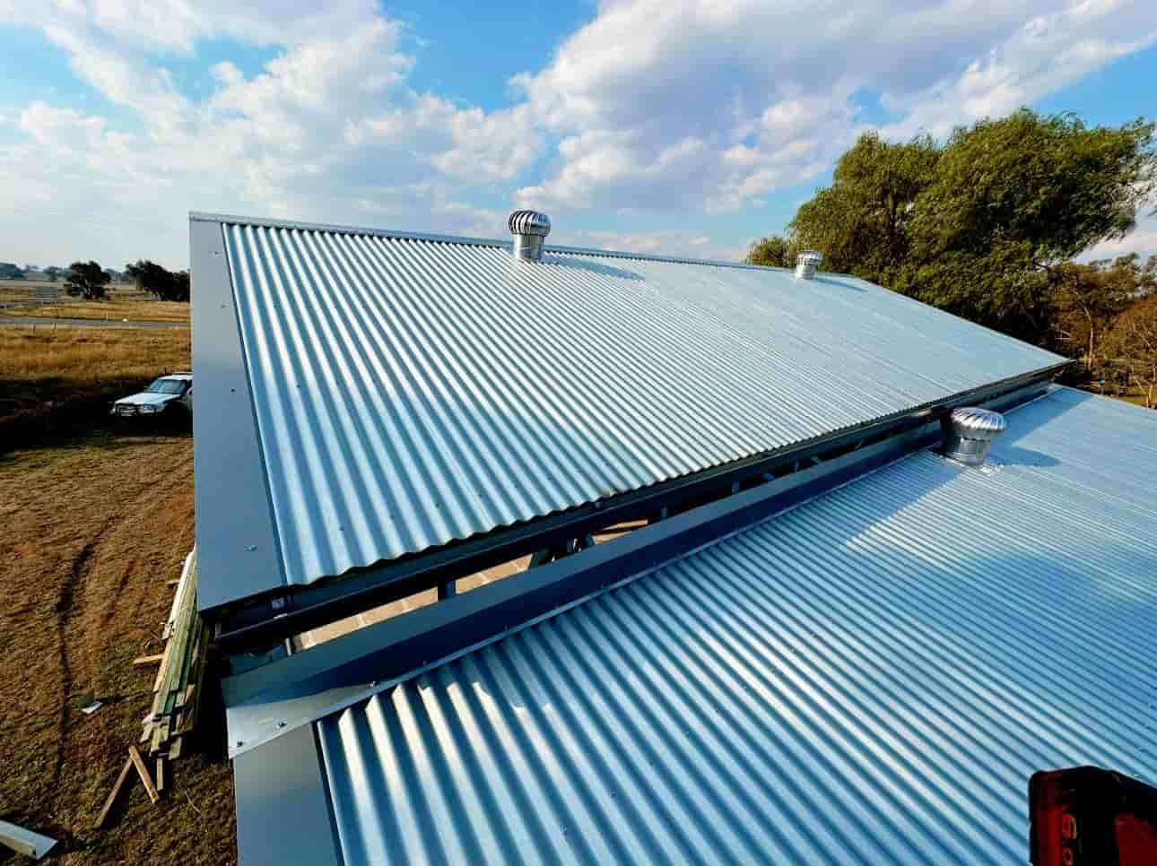 The Roof of a Building is Made of Corrugated Metal — Essential Roofing and Plumbing in Temora, NSW