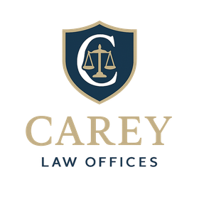 Logo for Carey Law Offices: Navy and gold shield with a "C" and scales of justice above "Carey Law Offices".