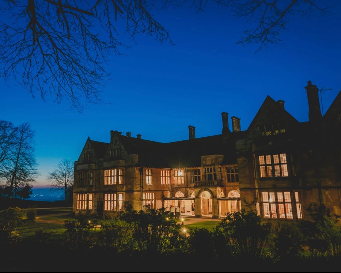 A large building with a lot of windows is lit up at night.