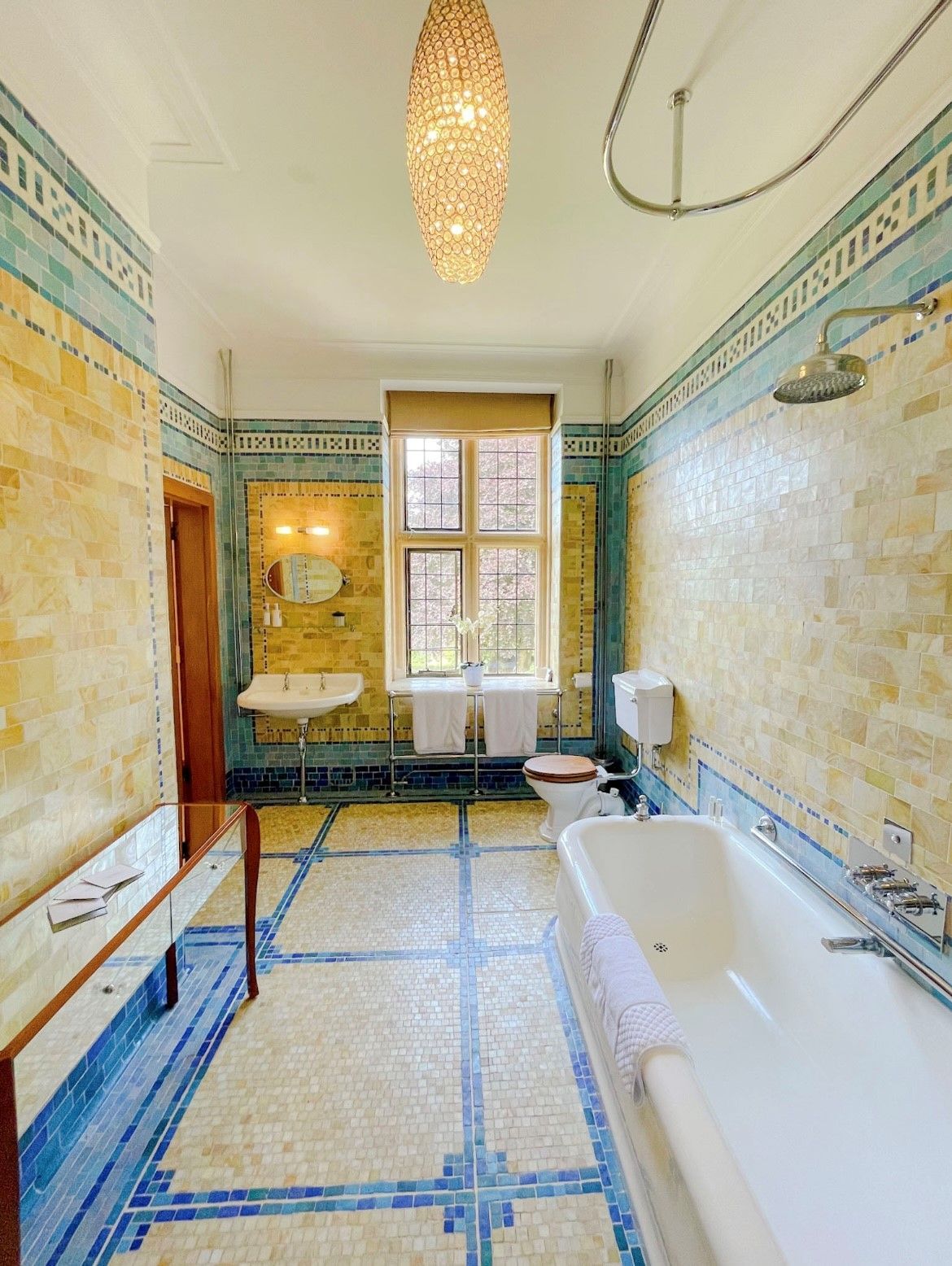 A bathroom with a bathtub , toilet , sink and mirror.