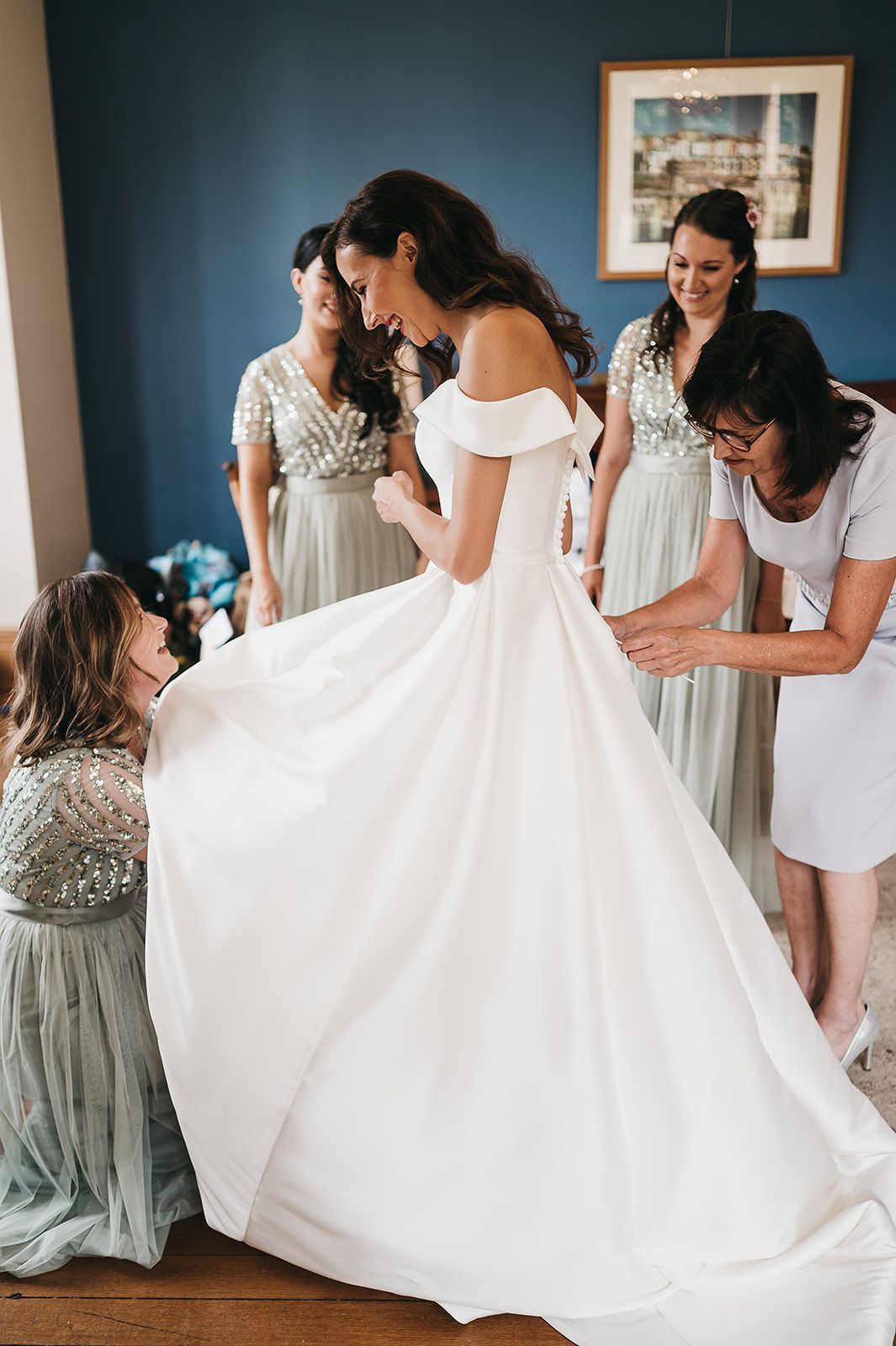 A bride is getting ready for her wedding with her bridesmaids.