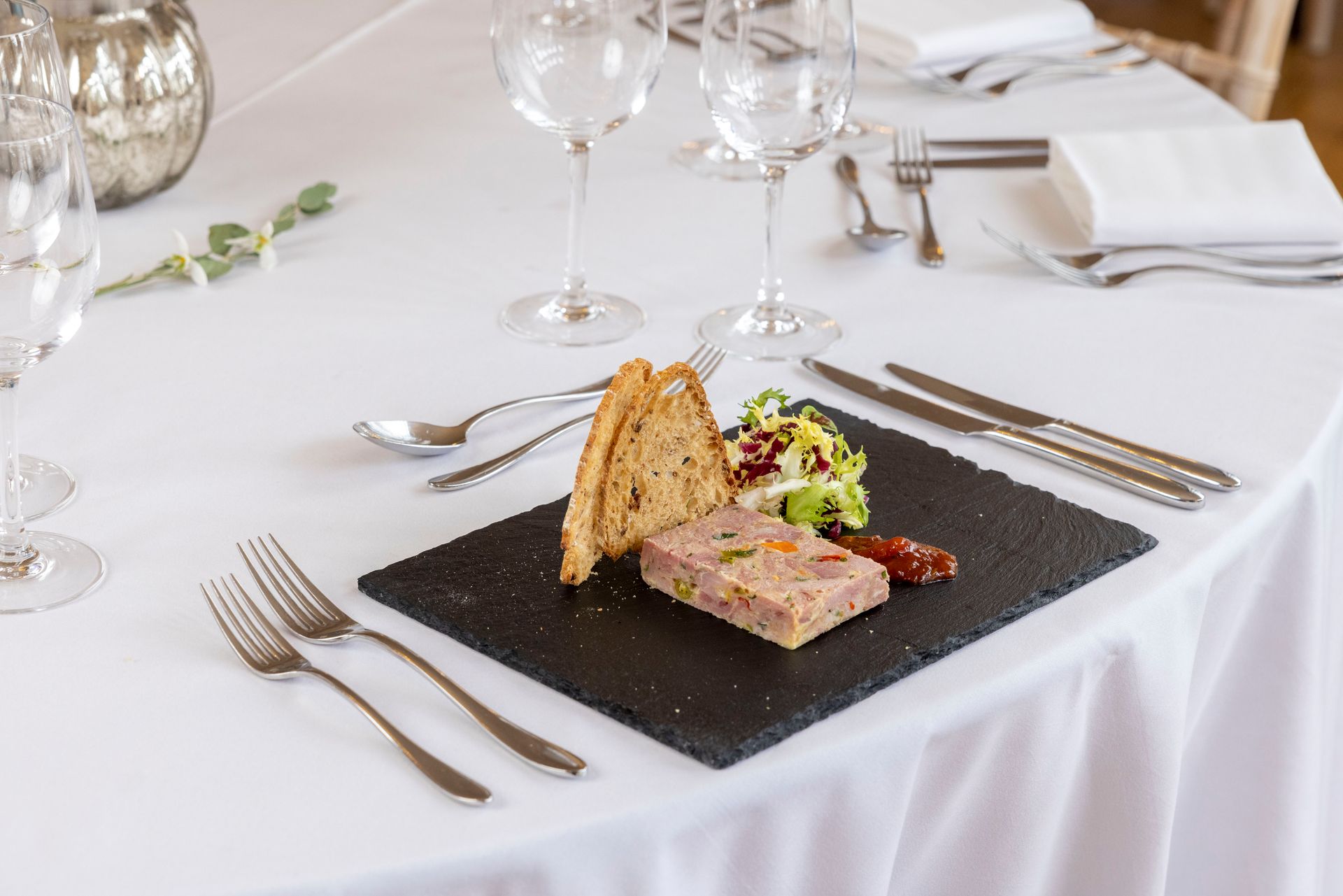 A plate of food is sitting on a table with silverware.
