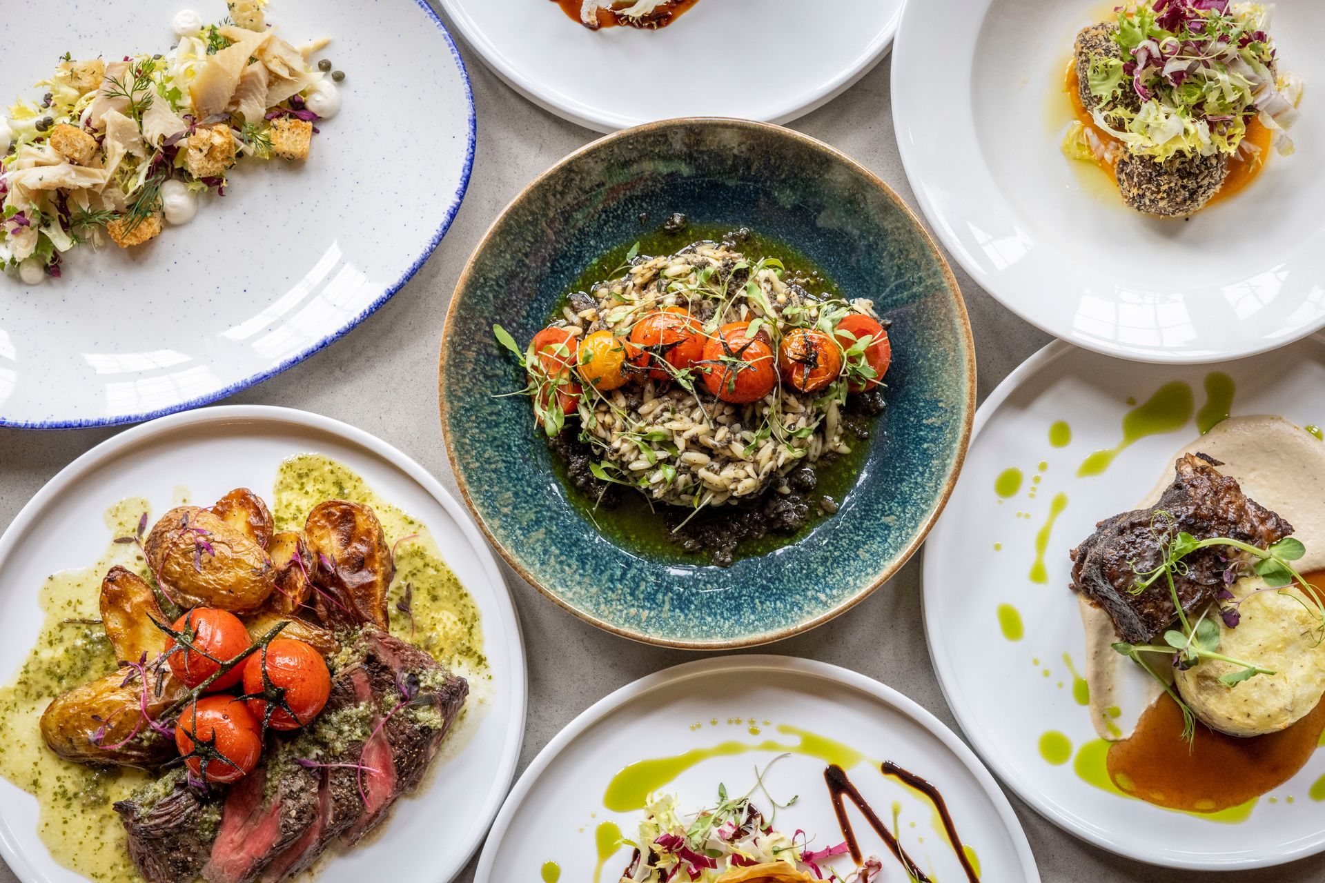 There are many different types of food on the plates on the table.