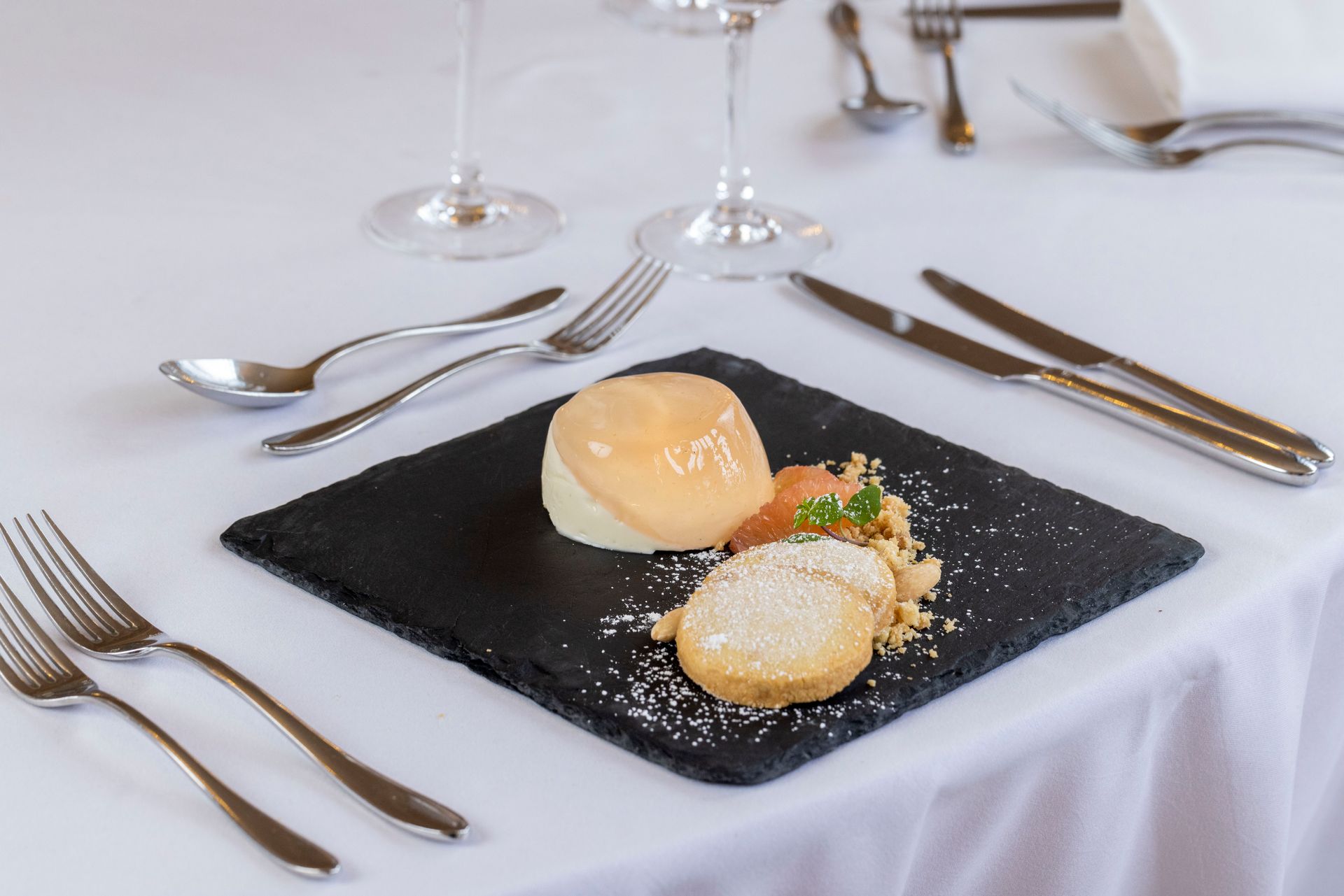 A plate of food is on a table with silverware.