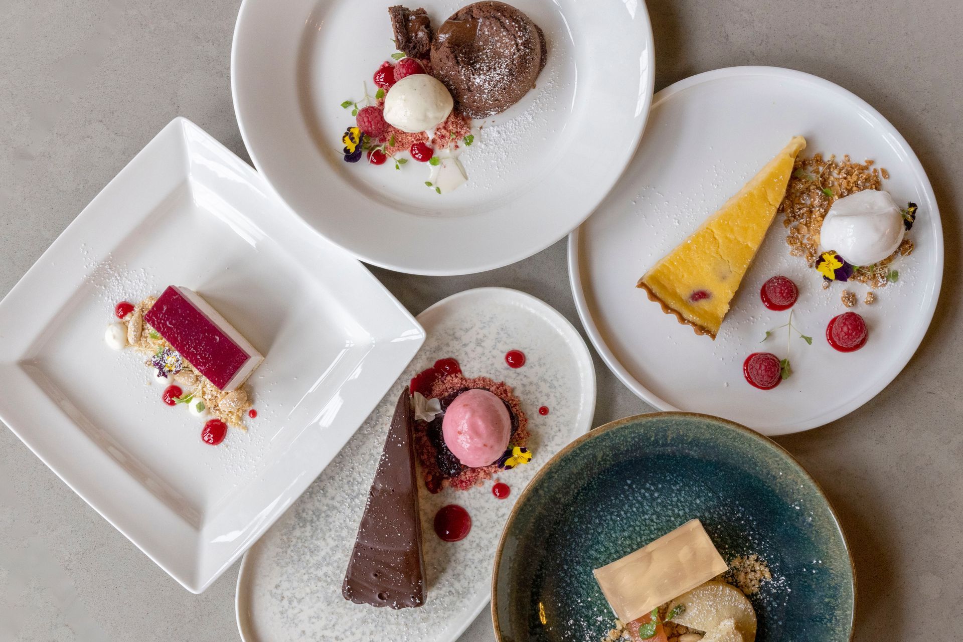 There are many different desserts on the plates on the table.