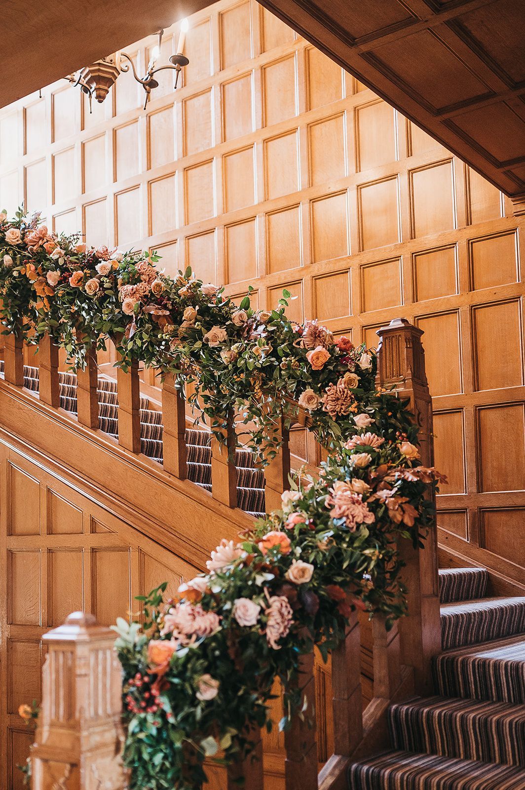 A wooden staircase decorated with flowers and leaves.