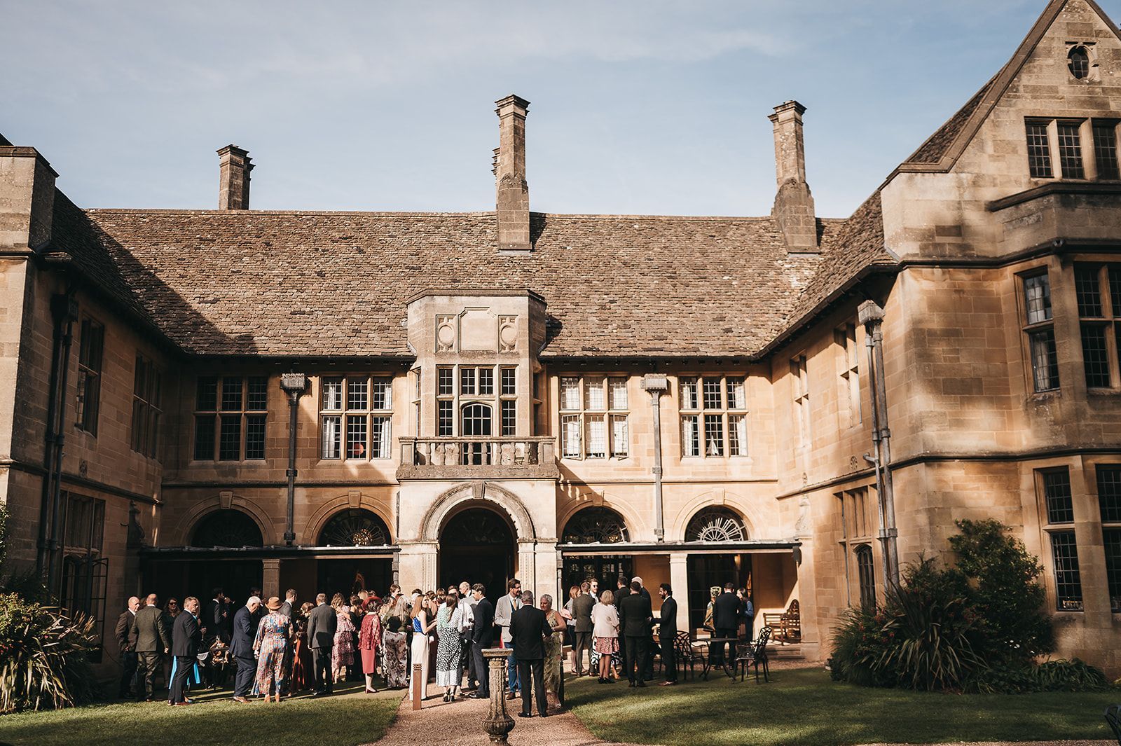 A group of people are standing in front of a large building.
