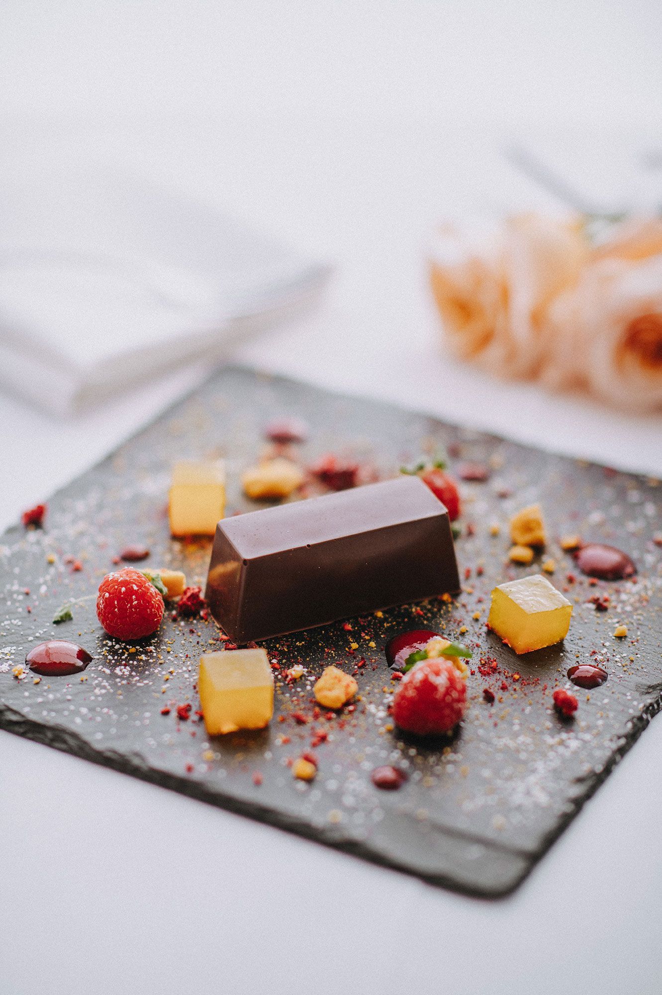A close up of a dessert on a slate plate on a table.