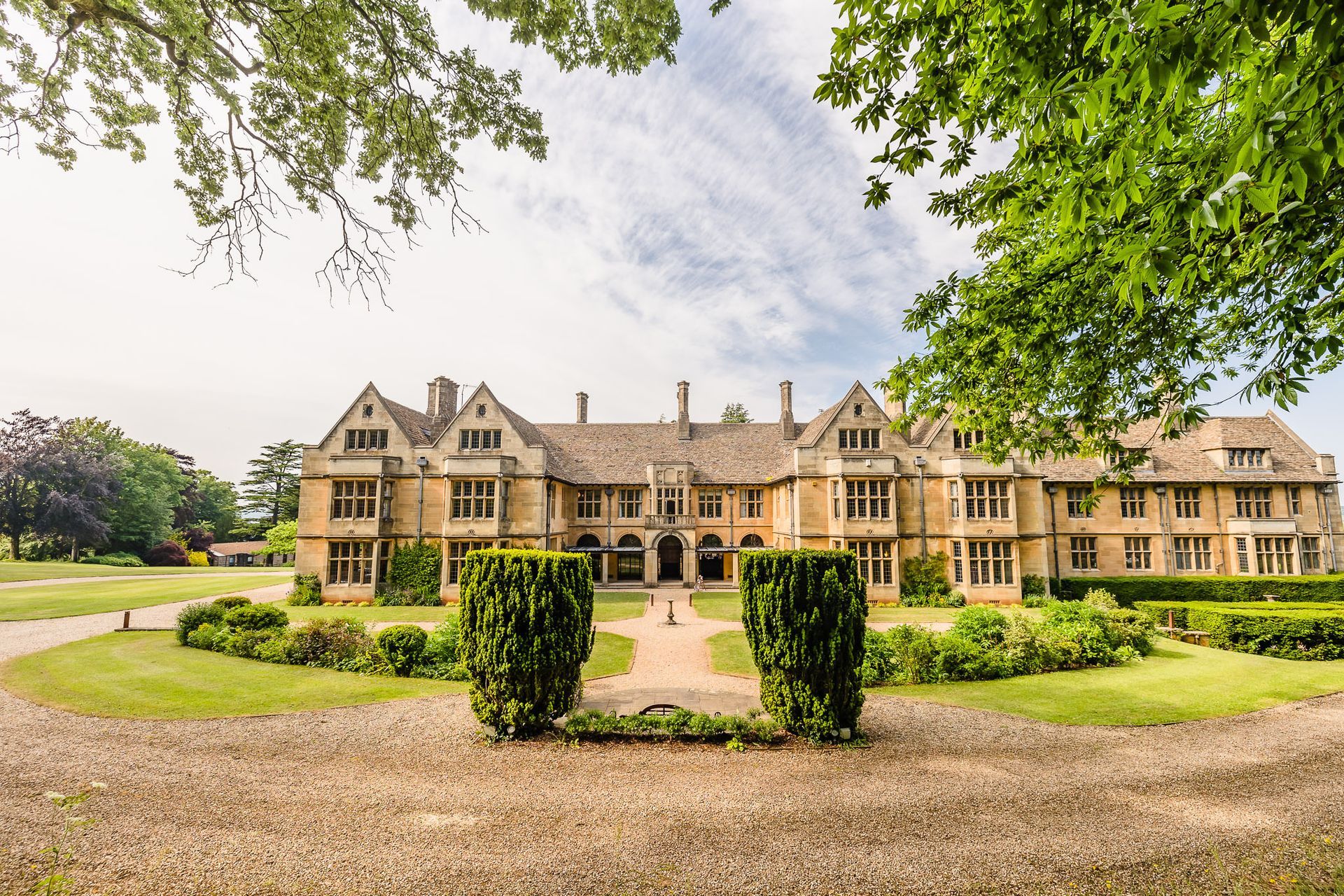 A large house with a lot of trees in front of it.