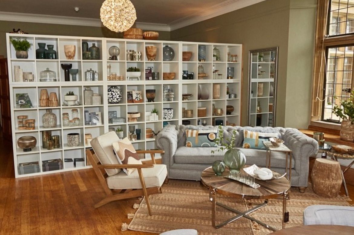 A living room with a couch , chairs , and a coffee table.
