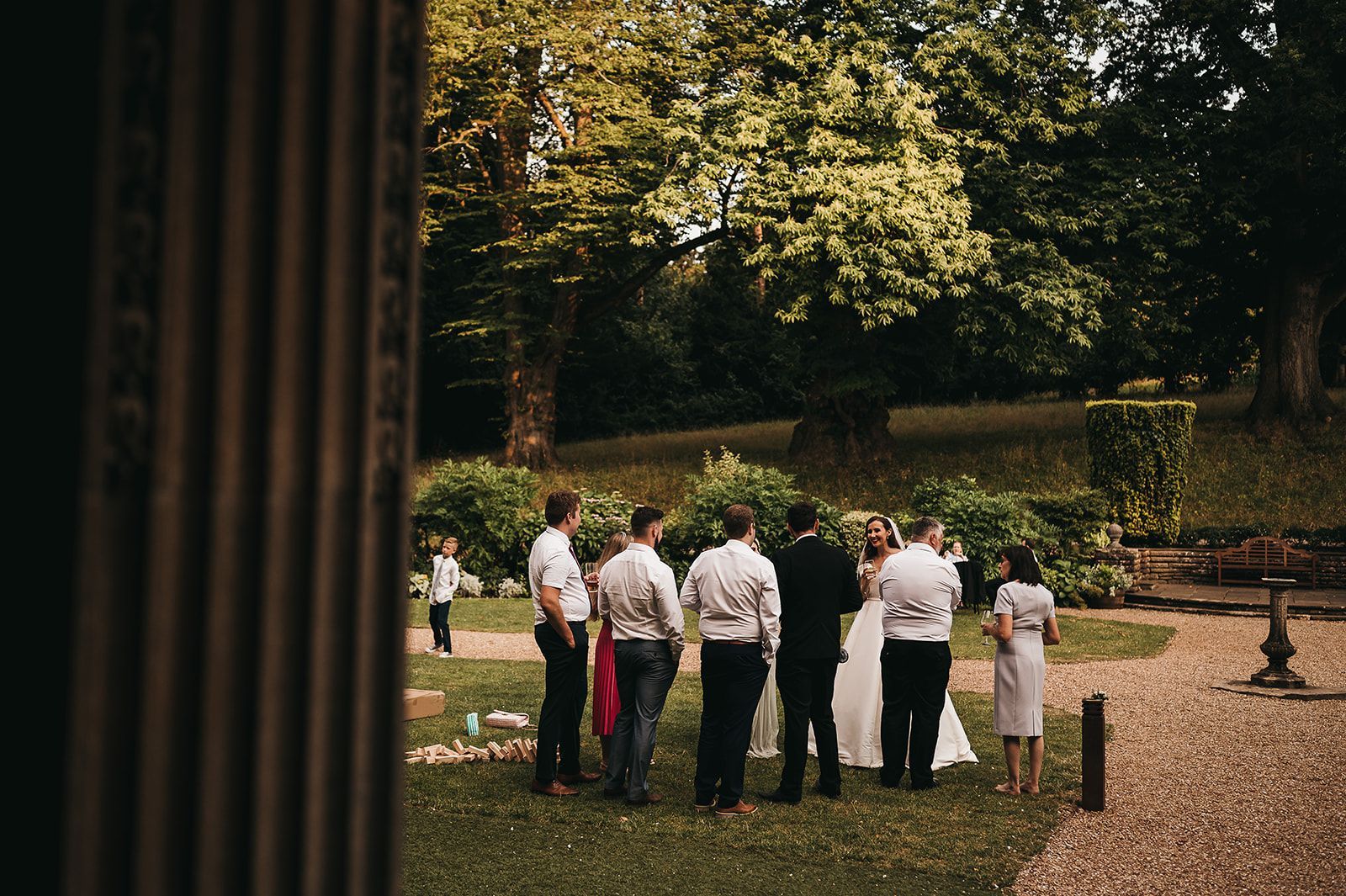 A bride and groom are standing in a field with their wedding party.