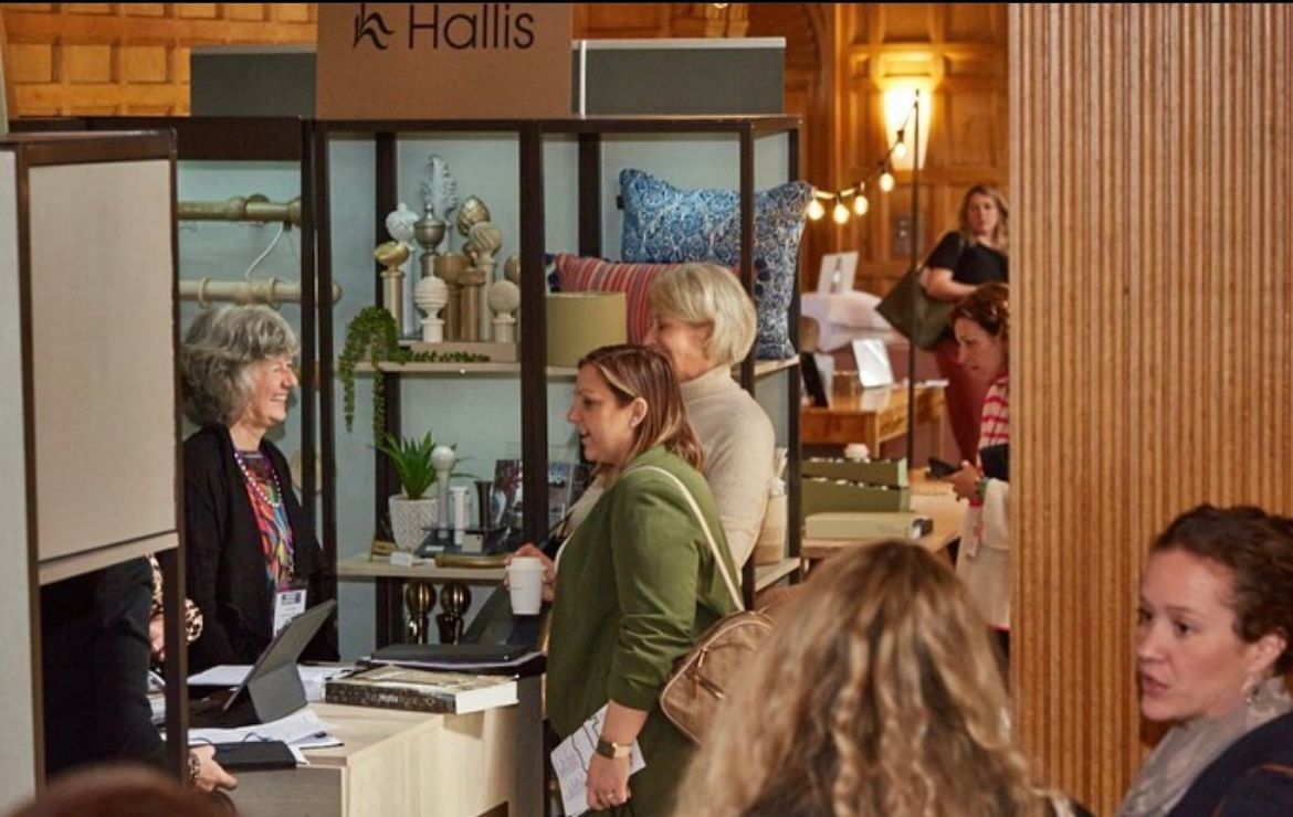 A group of women are standing in front of a sign that says halls