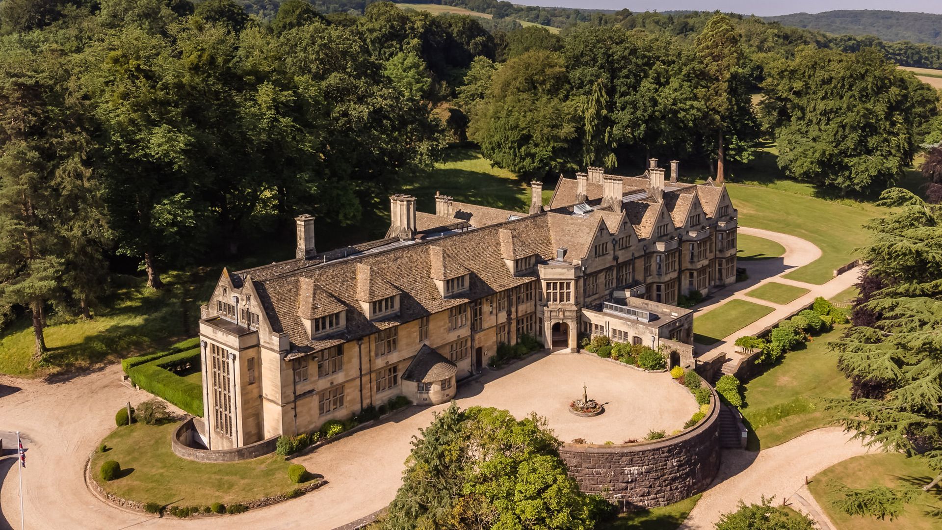 An aerial view of a large castle surrounded by trees.