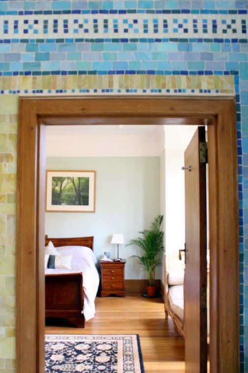 A bedroom with a bed and a picture on the wall