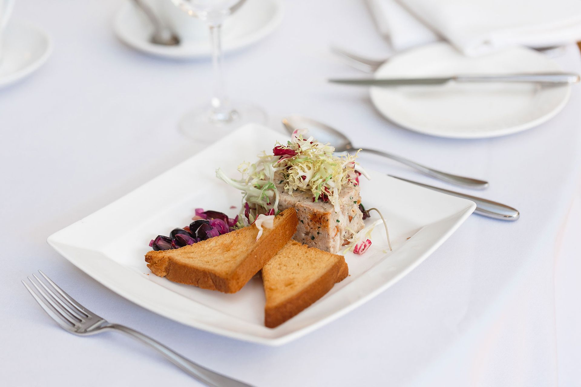 A plate of food on a table with silverware