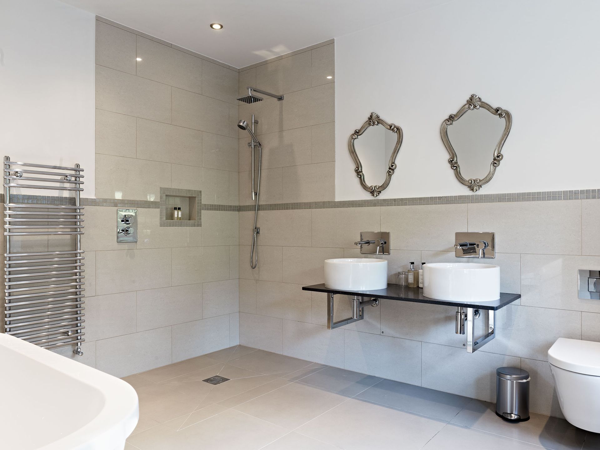 A bathroom with two sinks and a toilet