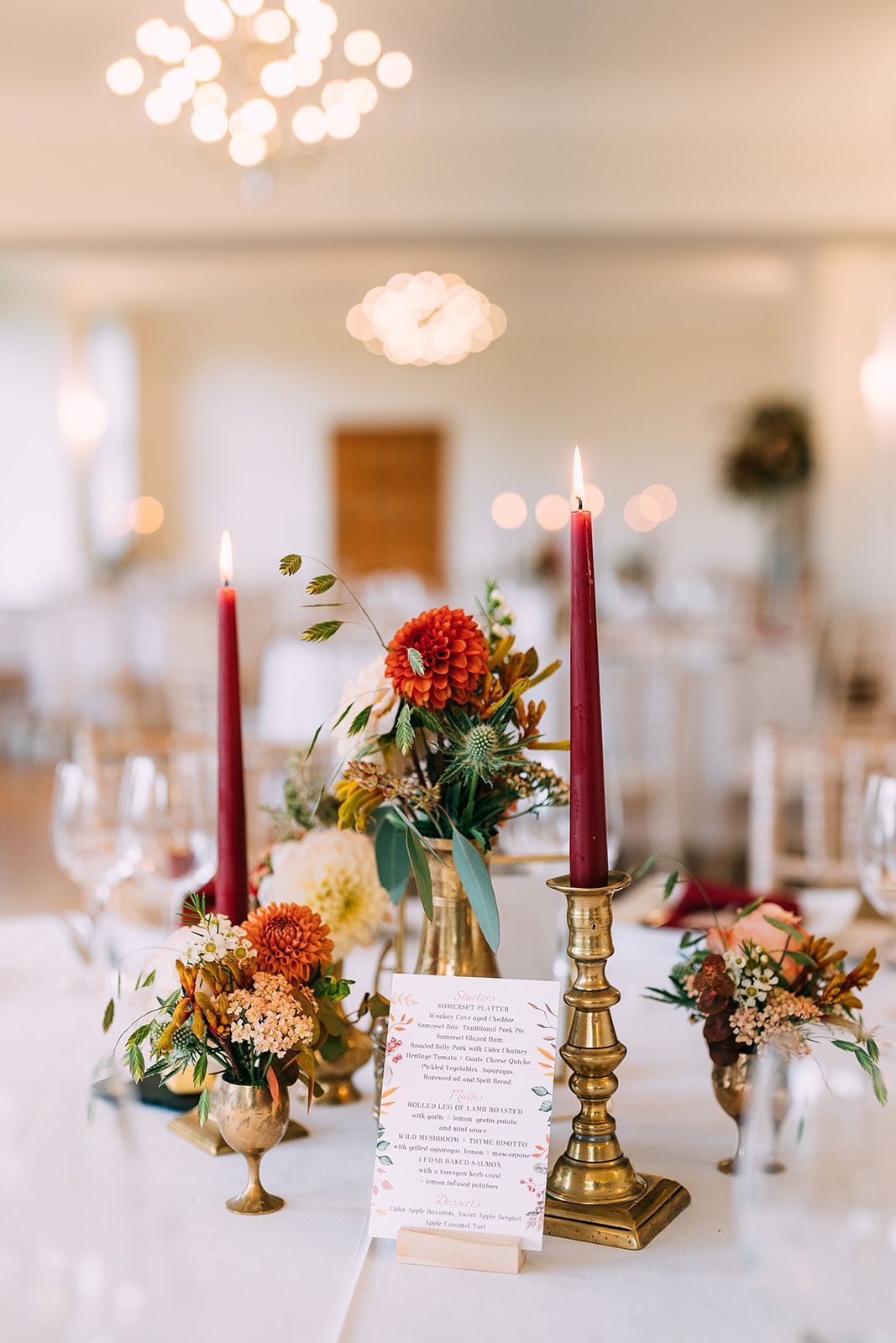 A table setting with candles and flowers on it.