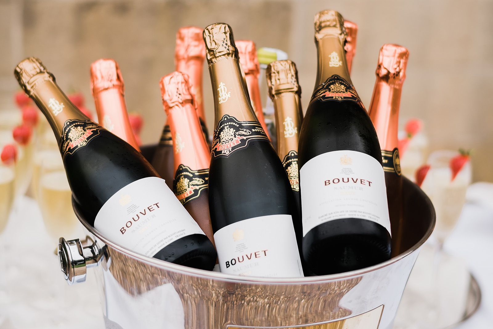 A bucket filled with bottles of champagne on a table.