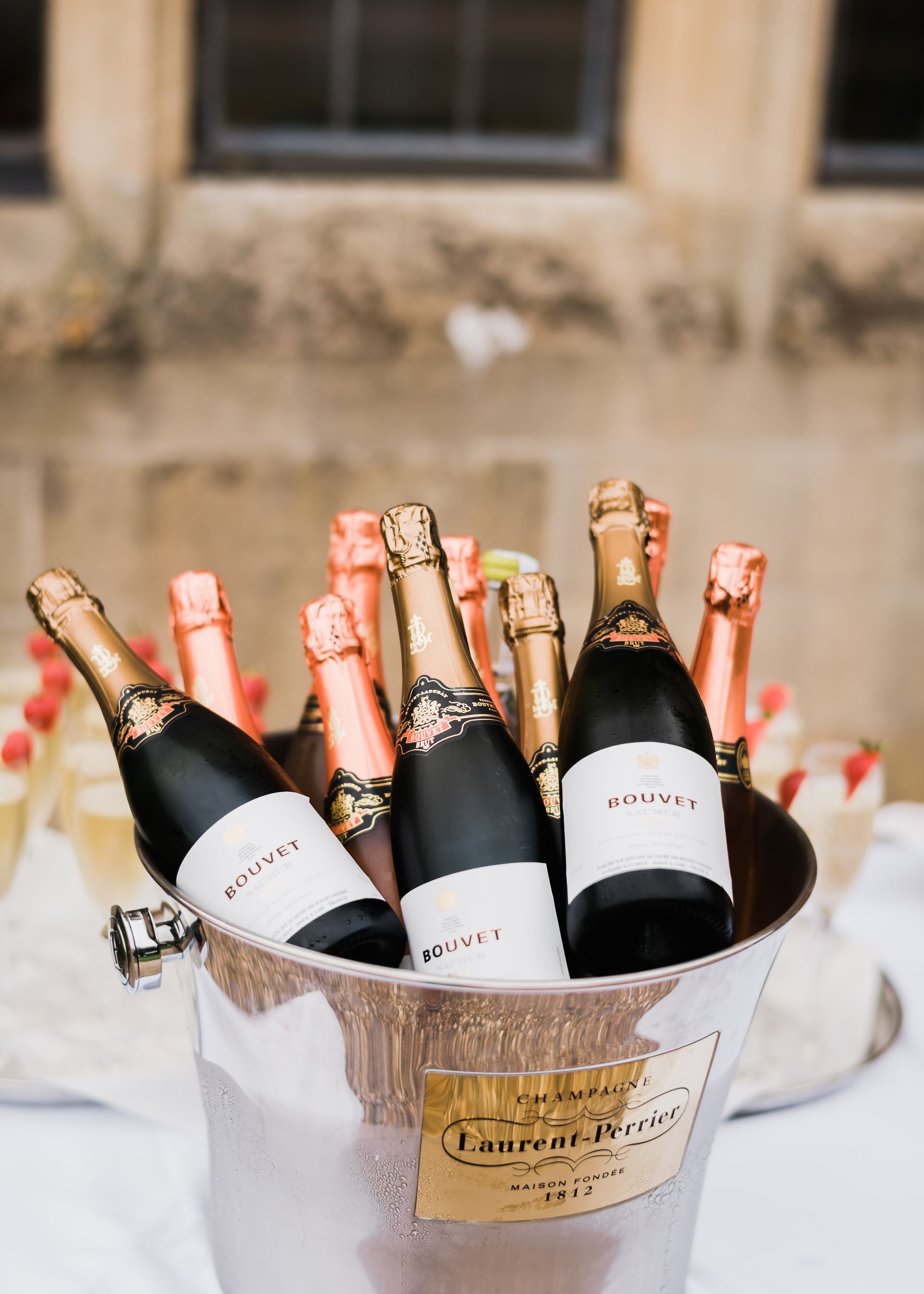 A bucket filled with bottles of champagne on a table.