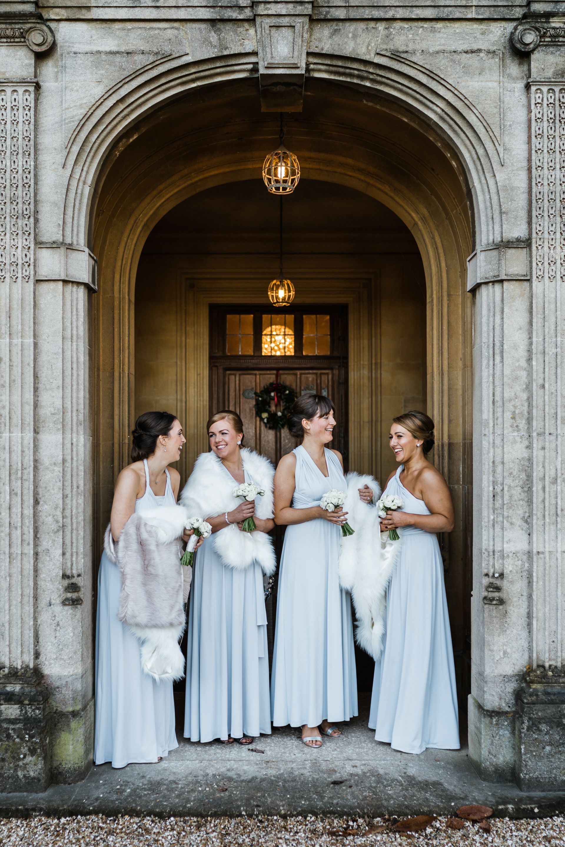 A group of bridesmaids are standing in front of a building.