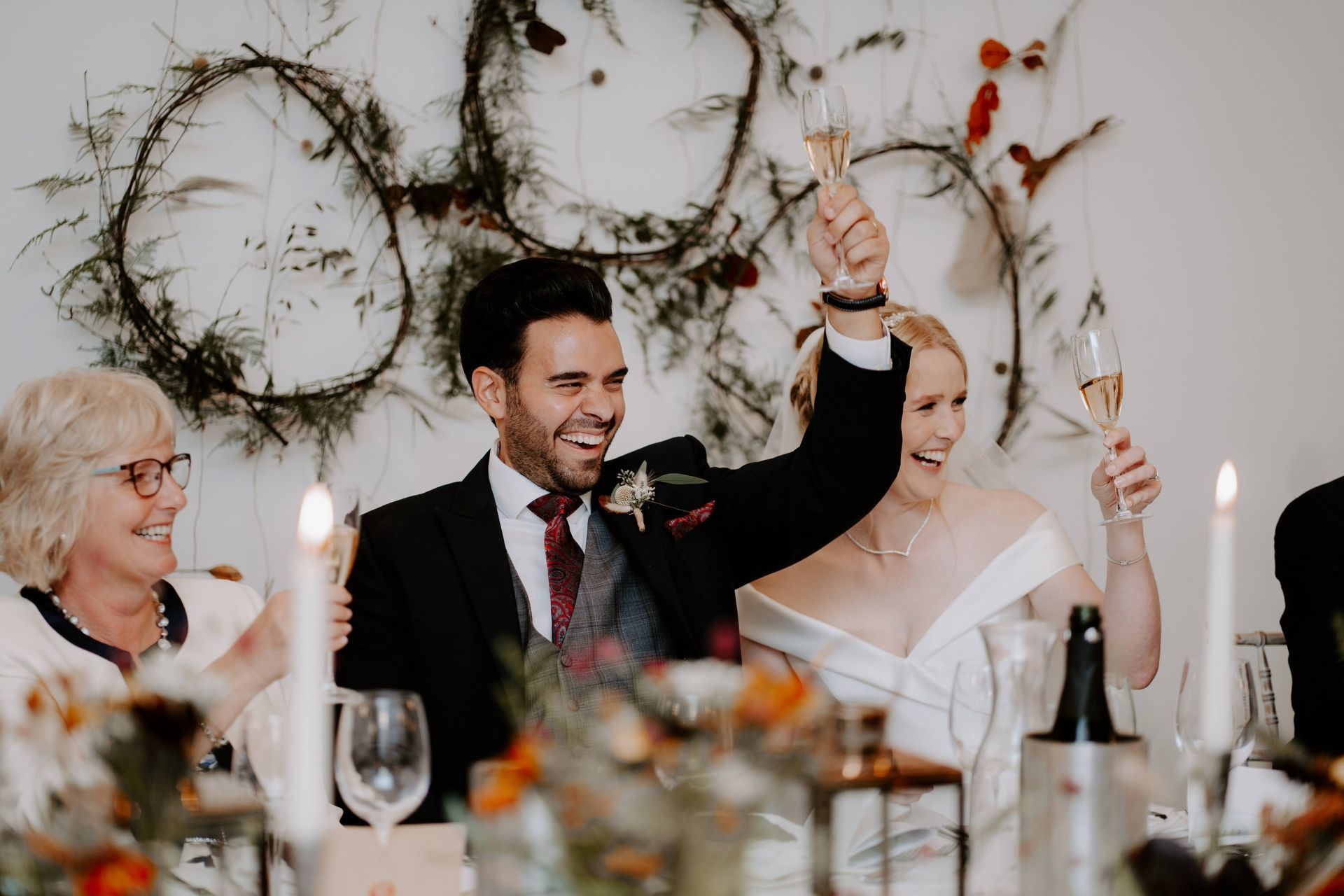 A bride and groom are toasting with champagne at their wedding reception.
