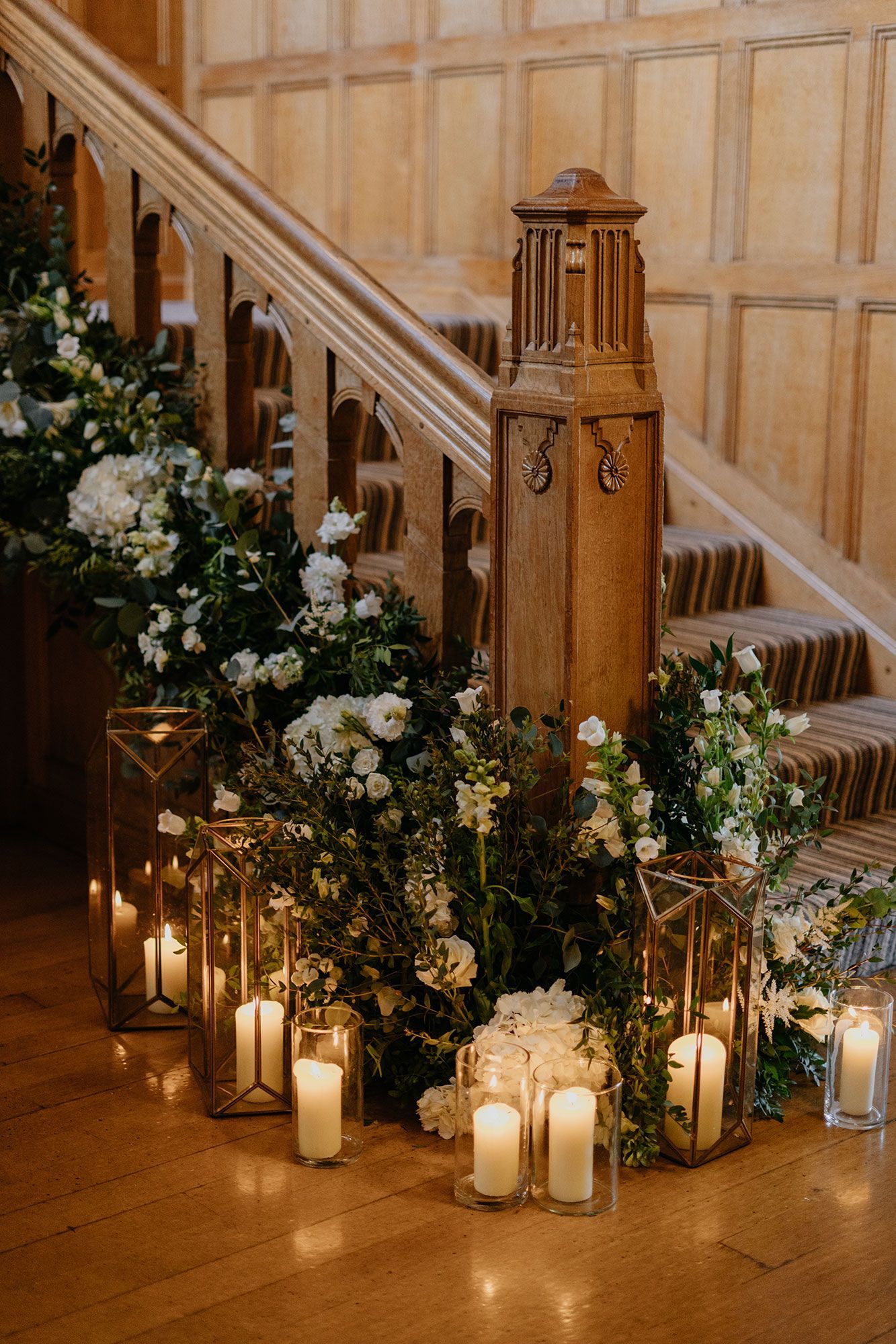 A wooden staircase decorated with flowers and candles.