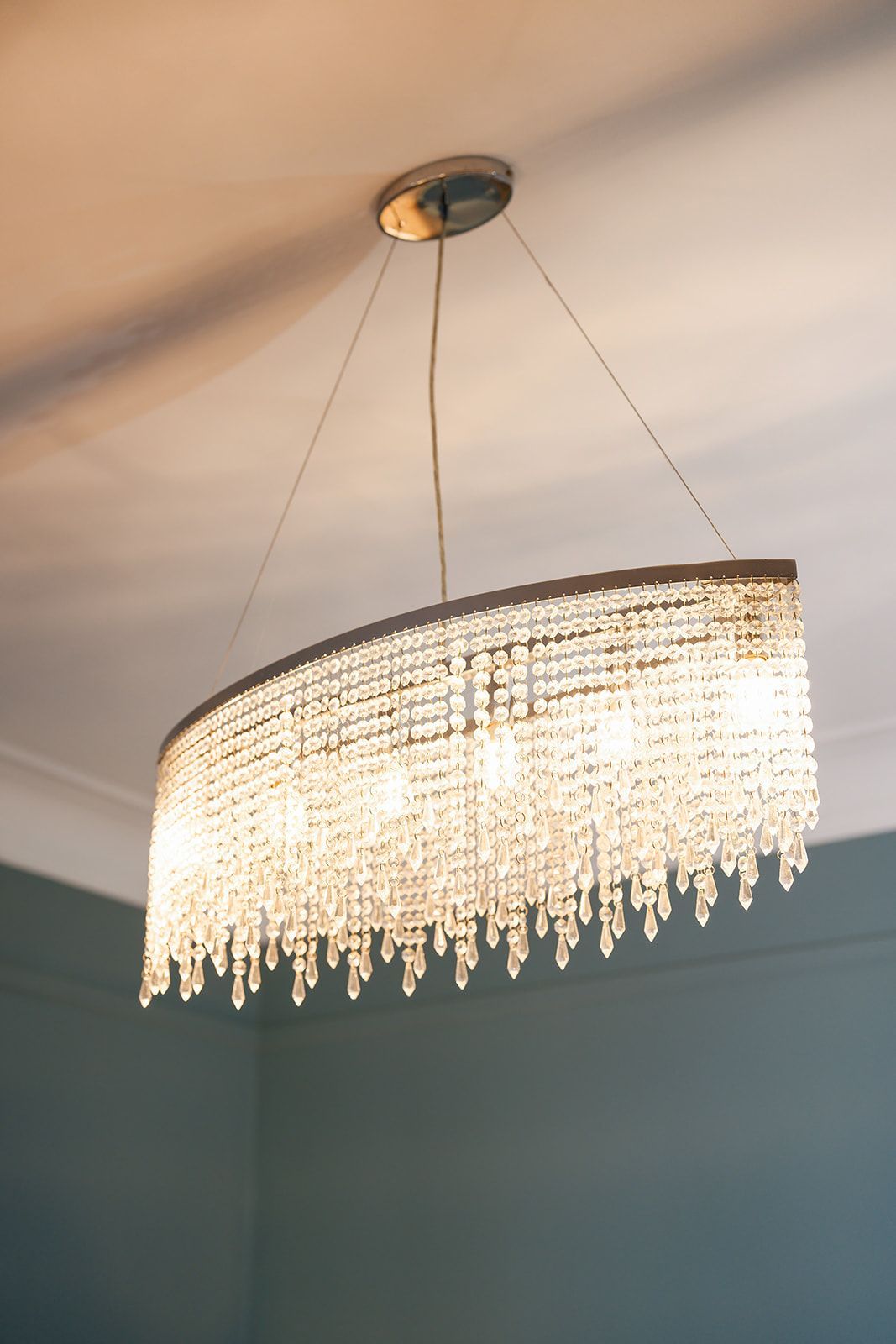 A large chandelier is hanging from the ceiling in a room.